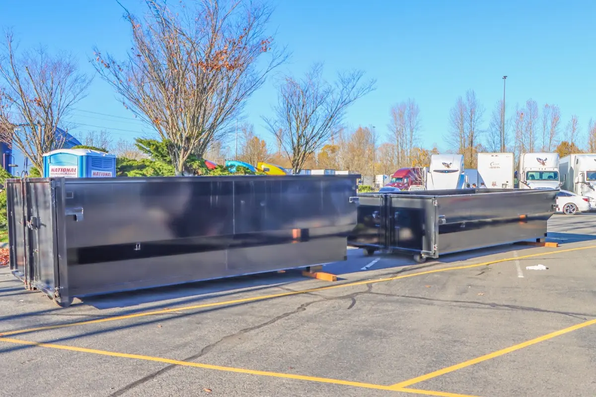Professional dumpster rental service with roll-off container on residential driveway in Bainbridge Island